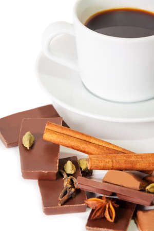 Cup of coffee, pieces of chocolate and spices isolated on white. Selective focusの写真素材