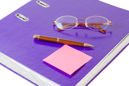 Violet folder with glasses and pen on white backgroundの写真素材