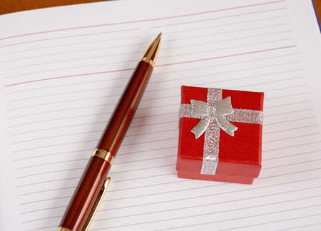 Personal planner with gift box and pen. Selective focusの写真素材