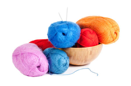 Knitting yarn  with knitting needles in bowl, isolated on whiteの写真素材