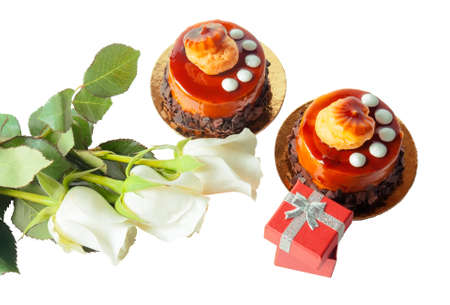 Cake, white roses and red gift box on white backgroundの写真素材