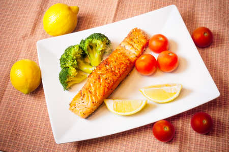 Salmon steak with broccoli and cherry tomatoesの写真素材