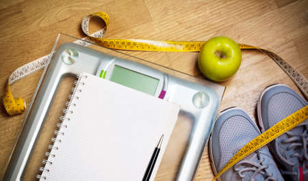 Sneakers, centimeter, green apple, notebook, scale. Weight loss,  healthy lifestyle conceptの写真素材