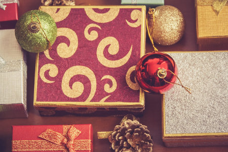 Gift boxes and christmas  balls. Selective focus on red ball. Vintage style 