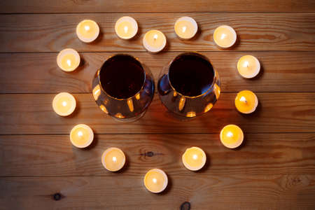 Wine with candles on wooden backgroundの写真素材