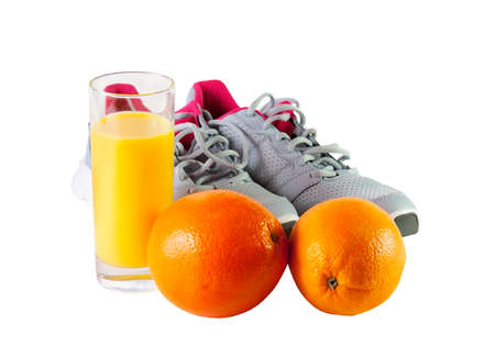 Sneakers,orange juice and oranges isolated on white  backgroundの写真素材