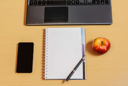 Workplace with notebook, smartphone and keyboardの写真素材