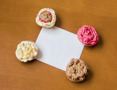 Cupcakes with a blank paper to write your own message. Top viewの写真素材