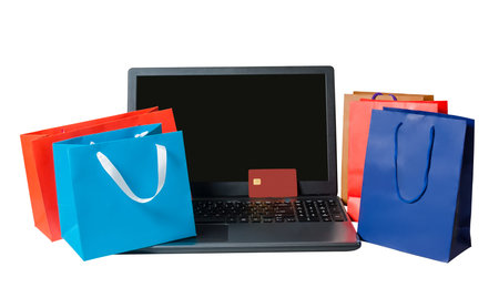 Shopping bags and open laptop isolated  on white background