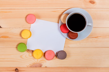 Blank card  and coffee cup with space for your text on wooden background. Top viewの写真素材