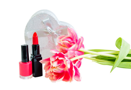 Red lipstick, nail polish, tulip flowers and silver gift box in heart shape isolated on white backgroundの写真素材