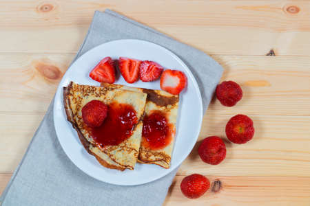 Crepes with fresh strawberries and jamの写真素材