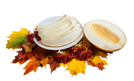 Slices of ripe melon on white plate isolated on  white backgroundの写真素材