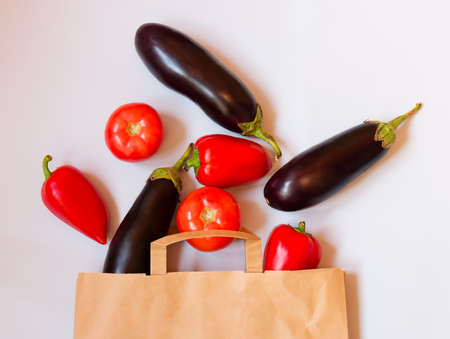 Fresh vegetables in paper bag on gray background.の写真素材
