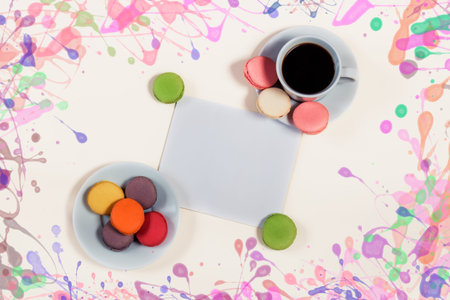 Coffee cup, macaroons and blank card with space for your textの写真素材