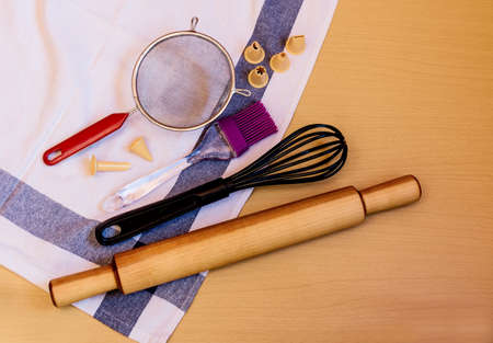 Kitchen baking utensils and kitchen towel on wooden tableの写真素材