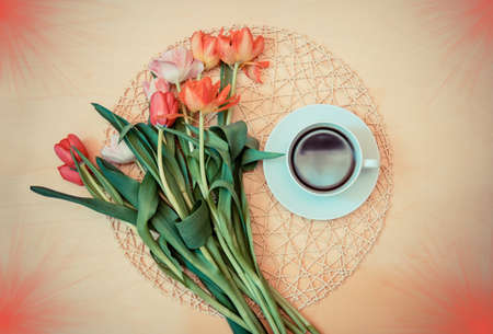 White cup of coffee with  tulips. Top view.の写真素材