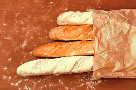 Baked bread on wooden table backgroundの写真素材