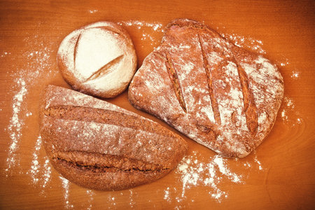 Different types of rye bread on wooden background