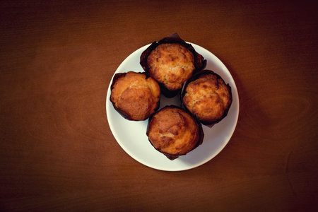 Vanilla muffins in paper cupcake holders. Top view.