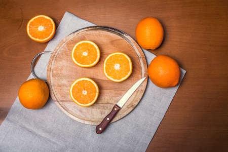 Fresh oranges on cutting board. Top view.の写真素材