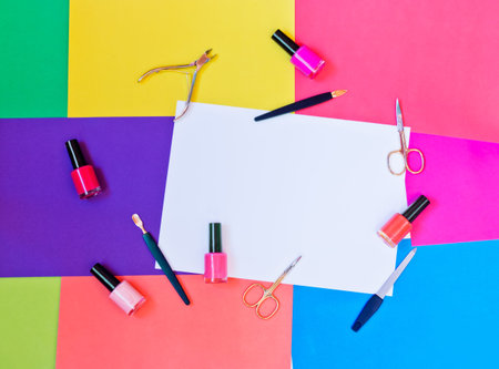 Manicure or pedicure equipment and nail polishes on colorful background. Top view with copy space.