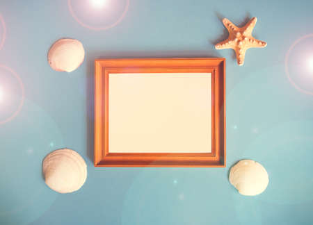 Summer beach holiday concept. Photo frame and seashell decoration on blue backgroundの写真素材