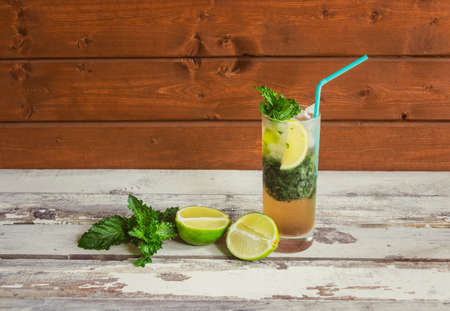 Mojito cocktail with lime and mint on aged wooden table. View with copy space.の写真素材