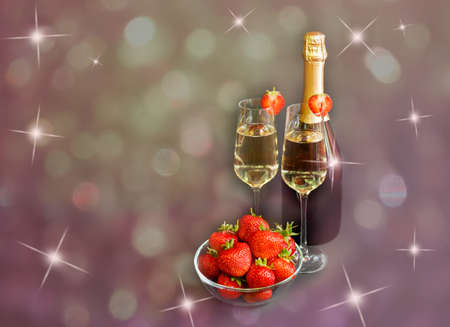 Two glasses of champagne, bottle of champagne and fresh strawberry on dark backgroundの写真素材