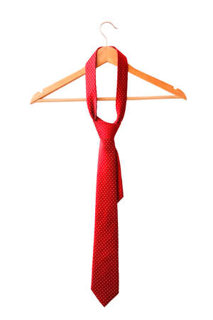 Red male tie hanging on the rack. Isolated on white background.の写真素材