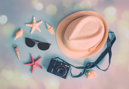 Things for summer holidays. Hat, sunglasses, photo camera, starfishes and seashells on blue...