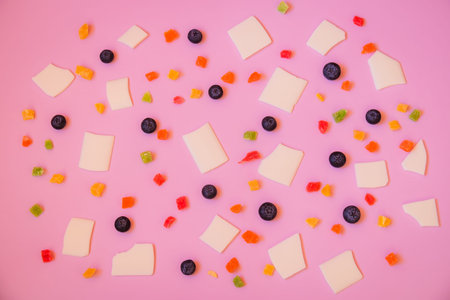 Blueberries, candied fruits and white chocolate chips as a background. Selective focus.
