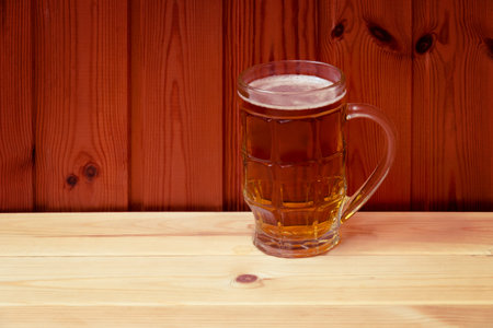 Beer mug on wooden table. View with copy space.