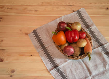 Wicker basket with different fresh farm vegetables. Top view with copy cpace.の写真素材
