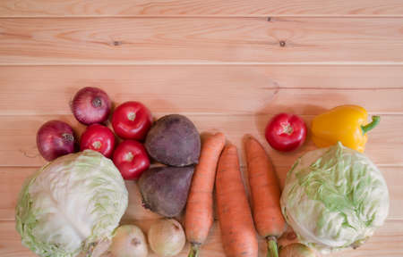 Border made of assorted fresh ripe vegetables on wooden background with copy space.の写真素材