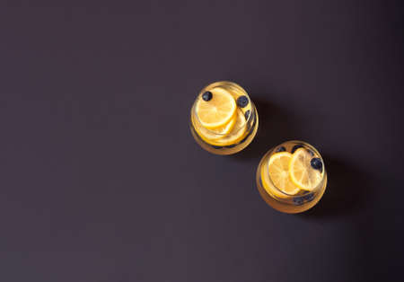 Glasses of summer lemonade with blueberries and lemon on dark background.  Top view, copy space.の写真素材