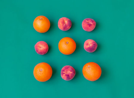 Pattern with ripe peaches and oranges. Abstract background. Fruits on green background.