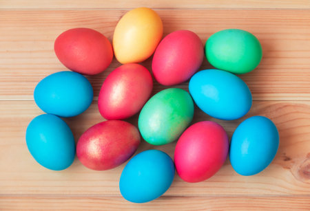 Colorful Easter eggs on wooden table. Top view.