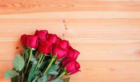 Red roses on wooden table. Top view with copy space.の写真素材