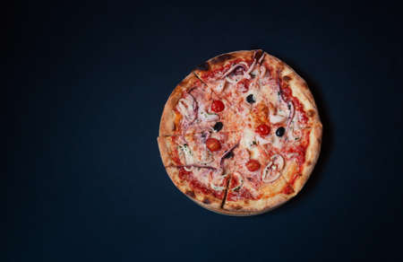 Delicious seafood pizza on dark background. Top view, copy space.の写真素材