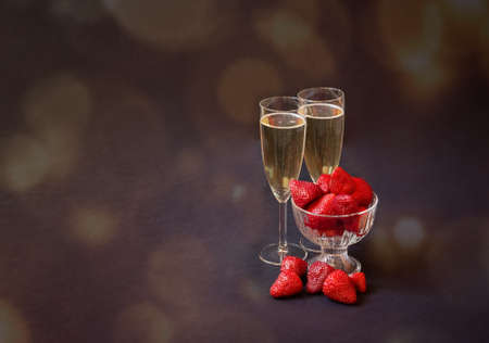 Two glasses of champagne and fresh strawberry on dark background. View with copy space.の写真素材