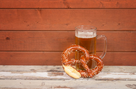 Beer mug and soft pretzel on aged wooden table. view with copy spaceの写真素材
