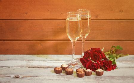 Glasses of champagne, red roses and chocolate candies. Concept of Valentine's Day. view with copy space.の写真素材