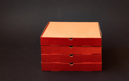 Cardboard pizza boxes on dark background. view with copy space.の写真素材