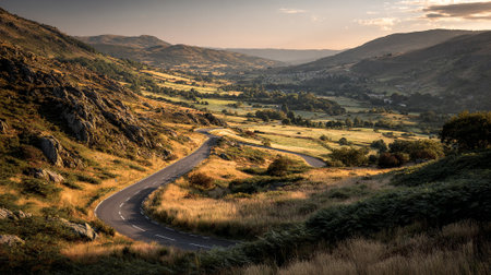 Curvy Mountain Road at Sunrise through Beautiful Scenic Welsh Landscapeの素材