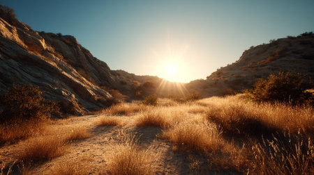 Sunlit Golden Meadow Between Rocky Hills Under a Clear Blue Skyの素材