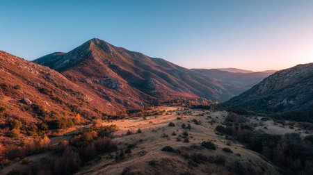Majestic Mountain Range at Sunrise with a Warm, Golden Glowの素材