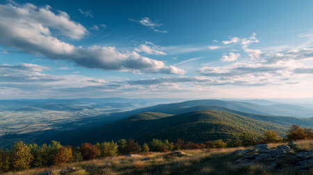 Breathtaking view over rolling hills under a cloudy sky, peaceful natural sceneryの素材