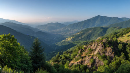 Scenic Vista of Green Mountains and Valley Landscape Under Clear Blue Skyの素材