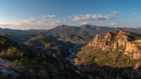 Mountain Valley Vista with River Flowing Through and a Blue Sky Viewの素材